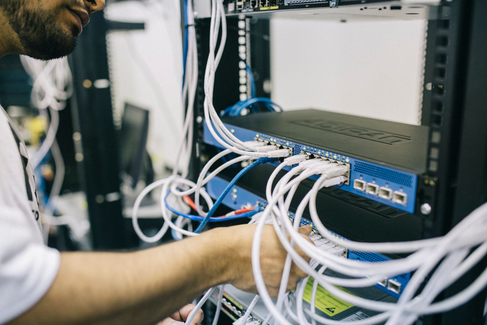 Tecnico informatico collega cavi di rete a un rack server, simbolo dei gateway VPN aziendali colpiti dalle falle zero-day di Citrix NetScaler