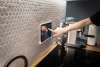 Pannello touch per il controllo della casa intelligente installato a parete in cucina